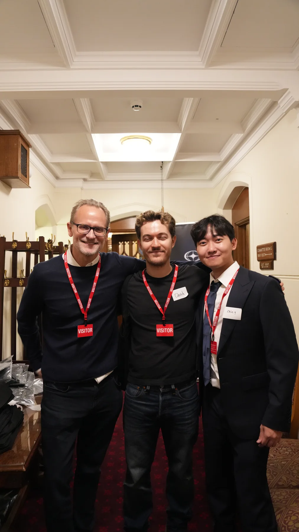 Three attendees posing for a portrait at the House of Lords