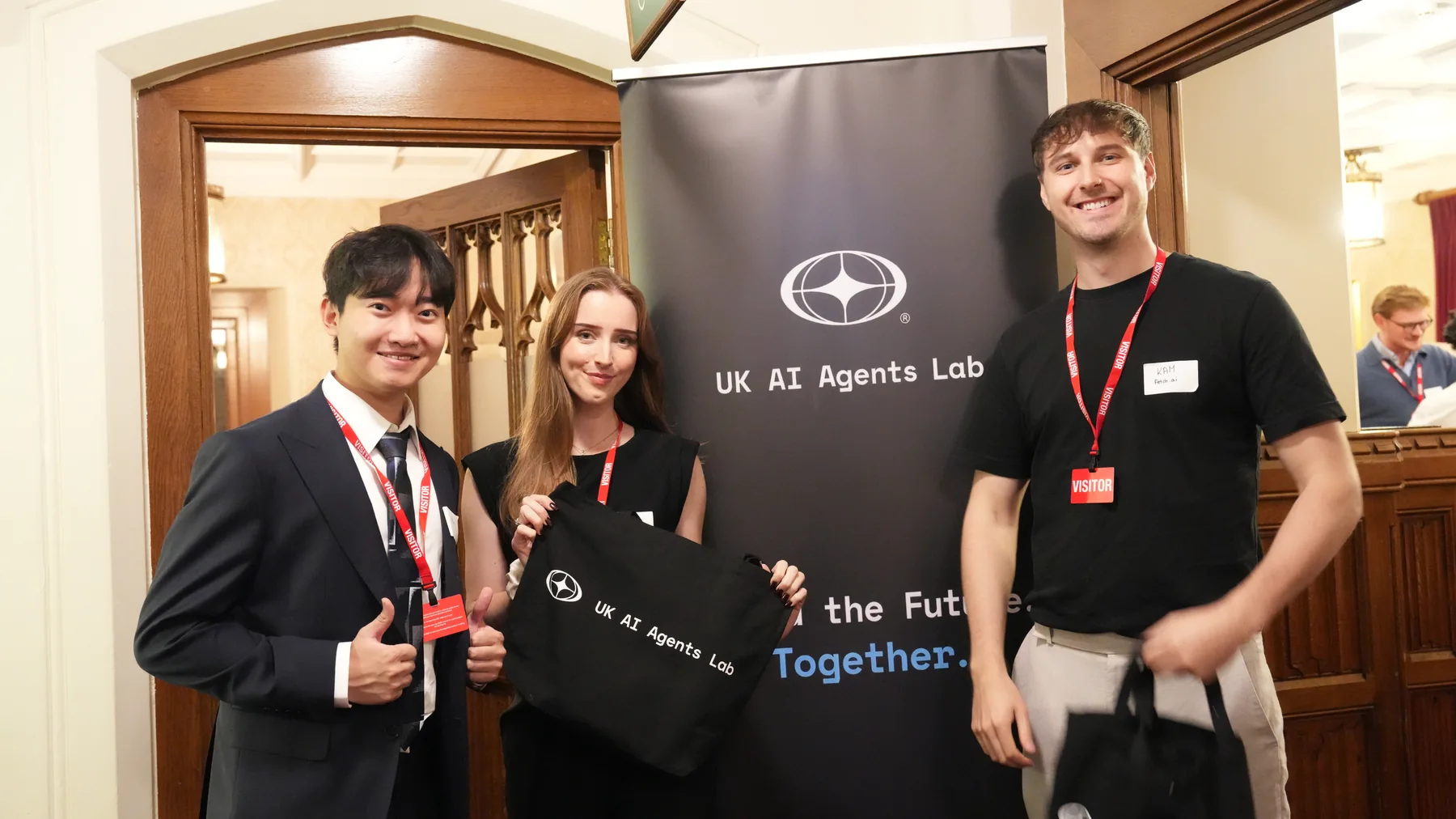Guests beside the UK AI Agents Lab banner at the House of Lords