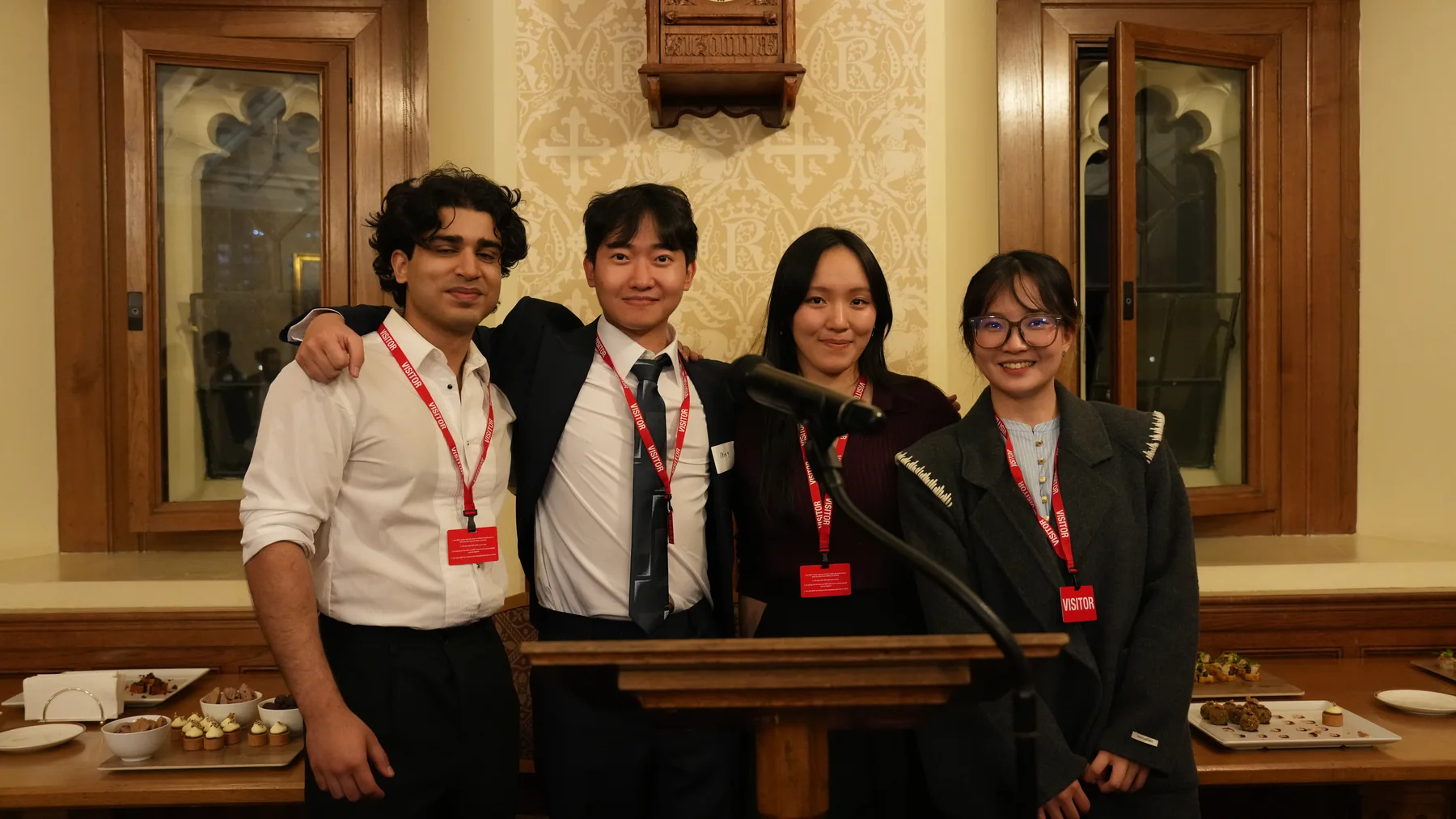Guests posing for a group portrait beside the lectern